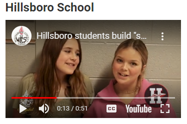  Two Fifth grade girls discussing their project.